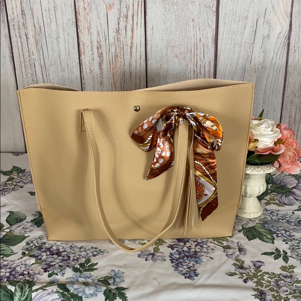 Tan colored purse with tassel/bow